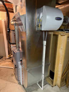 An indoor furnace unit with a whole-house humidifier integrated into the ductwork by A-1 HVAC in Kansas City, KS.