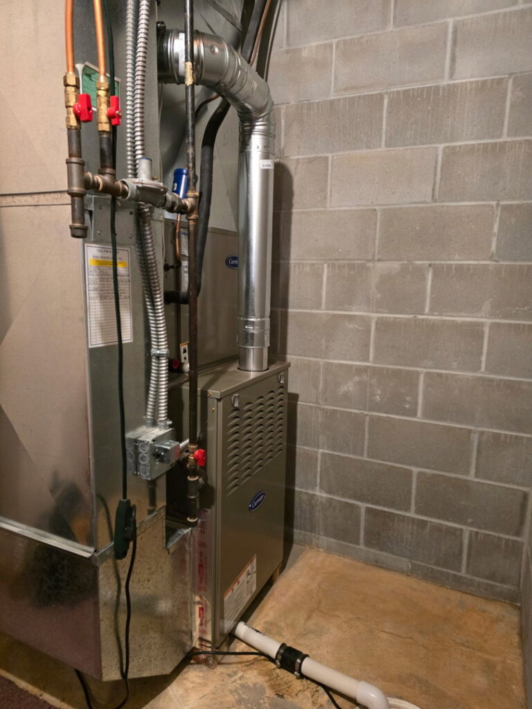 A furnace unit and associated piping installed in a basement by Jackson Home Appliance Heating & Cooling in Omaha, NE