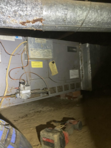 A furnace or air handler unit installed in a crawl space by Fox Heating and Air service in Hueytown, AL.
