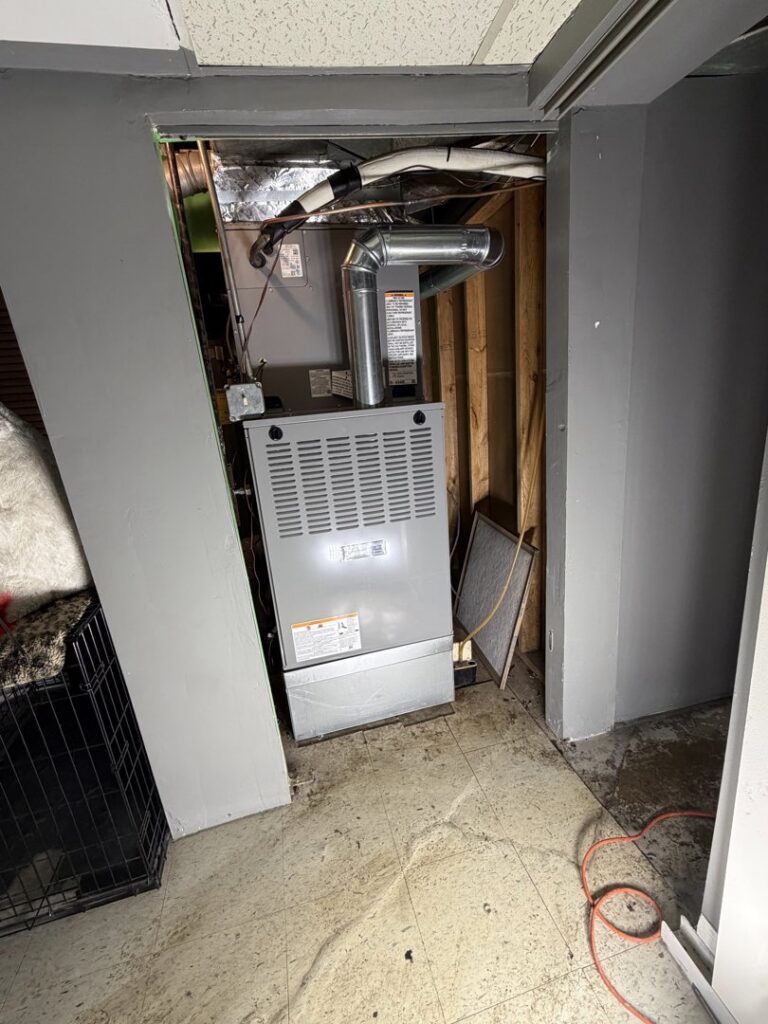 An indoor furnace installation in a utility closet with ductwork by Modern HVAC Technology in Chicago, IL.