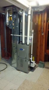 A new furnace installed in a utility room by Naranjo Heating & Cooling Specialist Inc. in Joliet, IL.