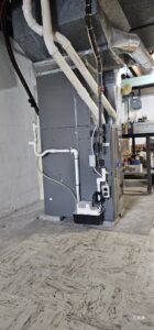 A furnace installation with ductwork and a condensate pump by Empire Heating & Air Conditioning in Decatur, GA