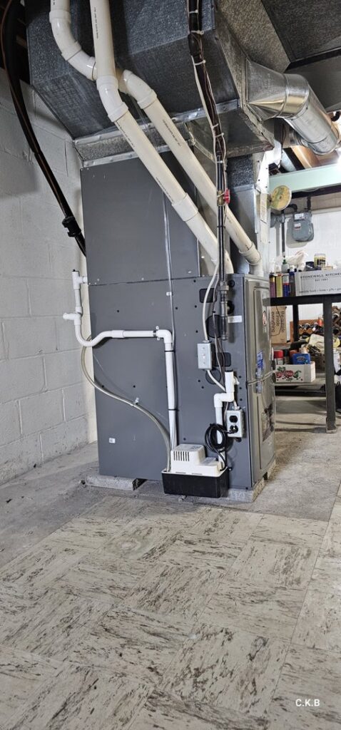 A furnace installation with ductwork and a condensate pump by Empire Heating & Air Conditioning in Decatur, GA