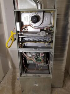 Detailed view of furnace interior components serviced by EPCTL Heating and Cooling in Byers, CO.