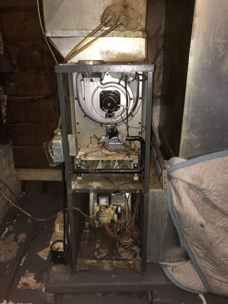 The interior components of a furnace unit being inspected by Wight's Heating & Air Conditioning in Rockford, IL