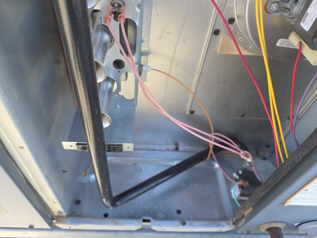 Close-up view of furnace interior showing wiring and components, serviced by One Way Heating And Cooling, LLC in Horizon City, TX.
