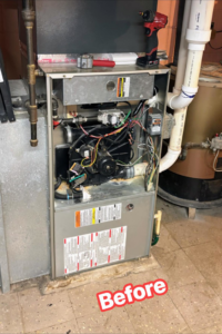 A furnace with its internal components exposed before repair by Polar Air Heating and Cooling in Omaha, NE