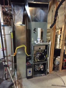 Internal components of a furnace being repaired or serviced by Any Climate Mechanical HVAC in Sandy, UT.