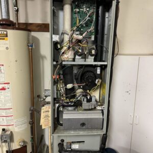 An open furnace unit showing internal components and wiring during a repair by Hodges Heating & Cooling in Owensboro, KY.