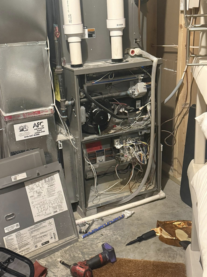 An open furnace unit undergoing repair or maintenance by Freedom Heating & Cooling in Lathrop, MO.