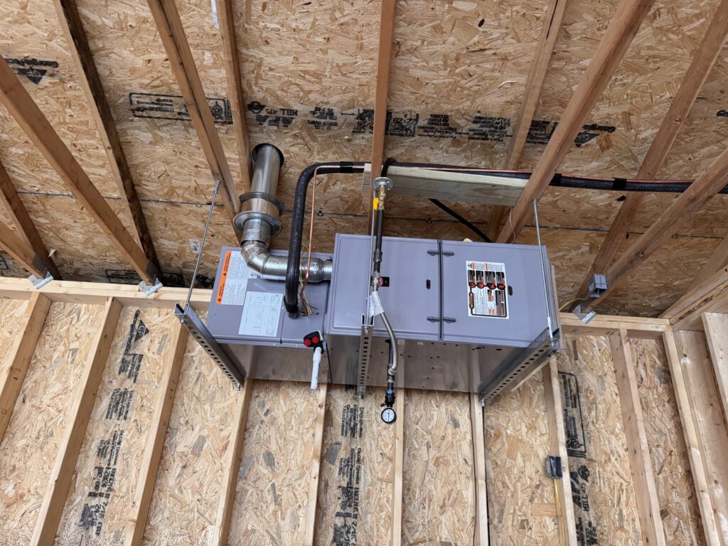 An open furnace showing internal components during a repair or maintenance service by TruLine HVAC in Cedar Rapids, IA.