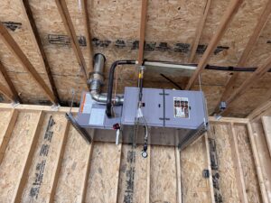 An open furnace showing internal components during a repair or maintenance service by TruLine HVAC in Cedar Rapids, IA.