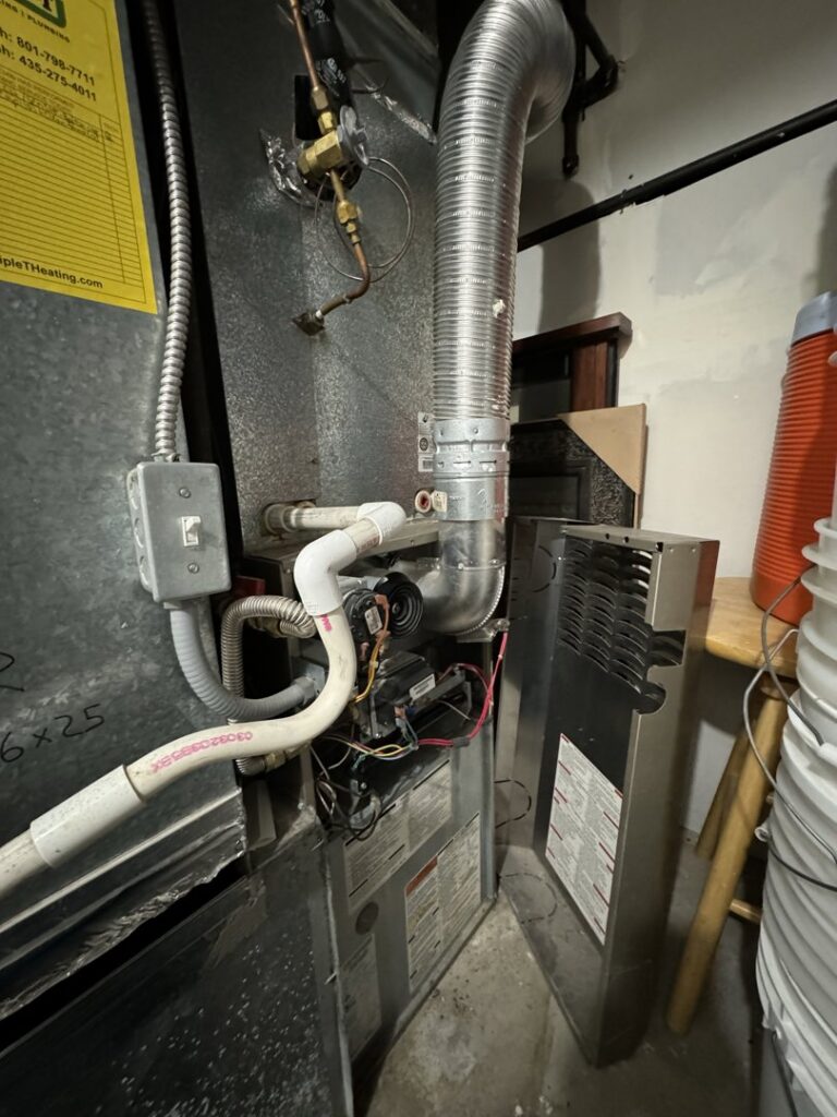 A furnace with exposed components, indicating repair or maintenance by EPIC Heating and Air in Loveland, CO