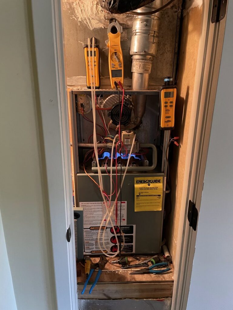 A furnace repair and service in progress with tools and gauges by Caballero's A/C & Heating in Marrero, LA.