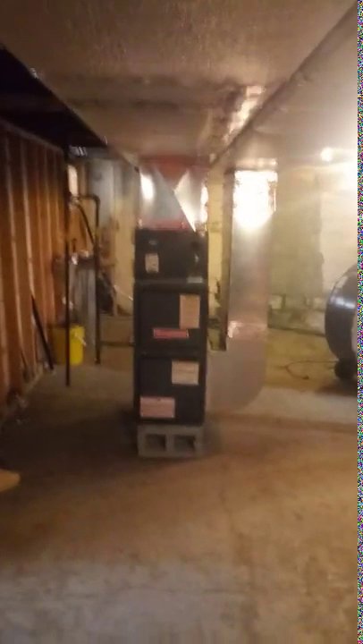 A furnace unit and associated ductwork installed in a basement by Bean'z Heating and Cooling in Chicago, IL.