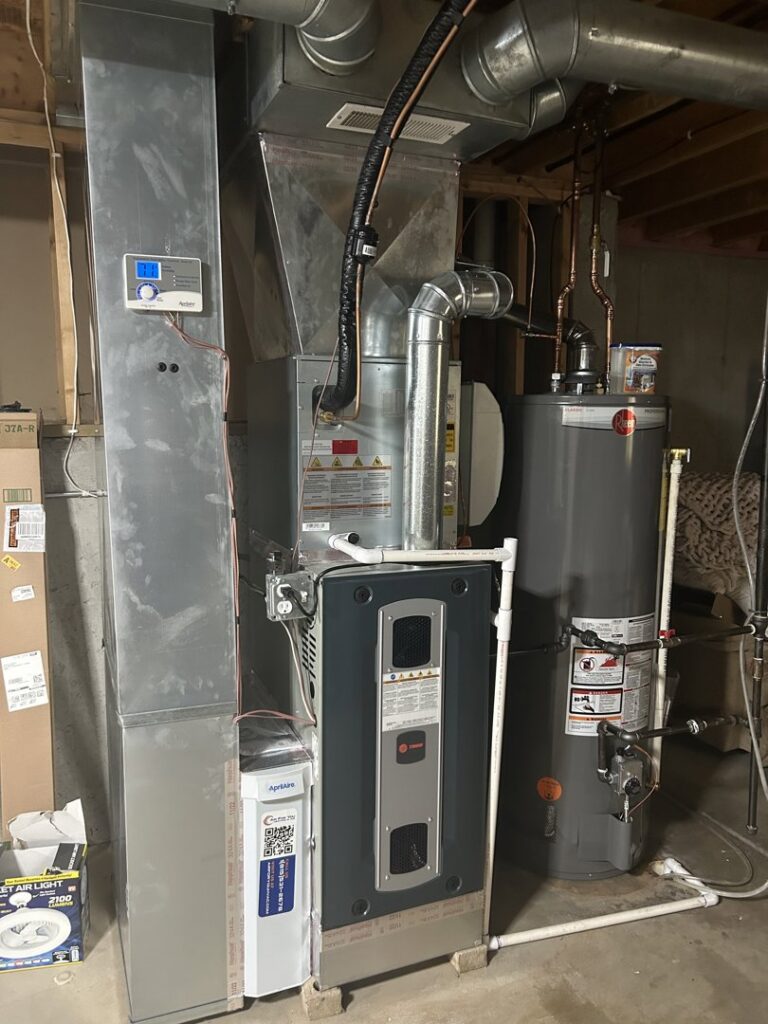 A new furnace, water heater, and associated ductwork installed in a basement by Air For You Heating and Air in Joliet, IL.
