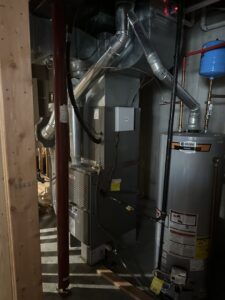 A comprehensive furnace, water heater, and ductwork system in a basement by Affordable Heating & Cooling LLC in Olathe, KS.