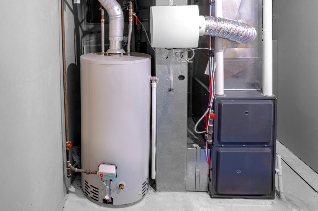 A residential furnace and water heater unit installed in a utility room by Basic HVAC in Indianapolis, IN.