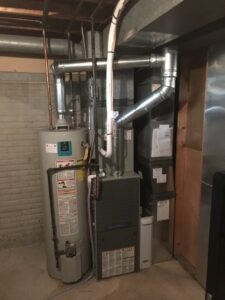 A new furnace and water heater installation in a basement by Comforttechs in Lincoln, NE.
