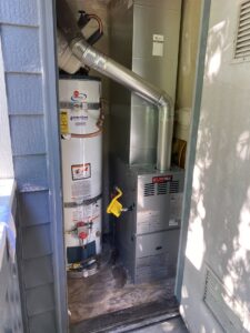 A new furnace and water heater installation in a utility closet by Heatwave Heating & Air LLC in Federal Way, WA.