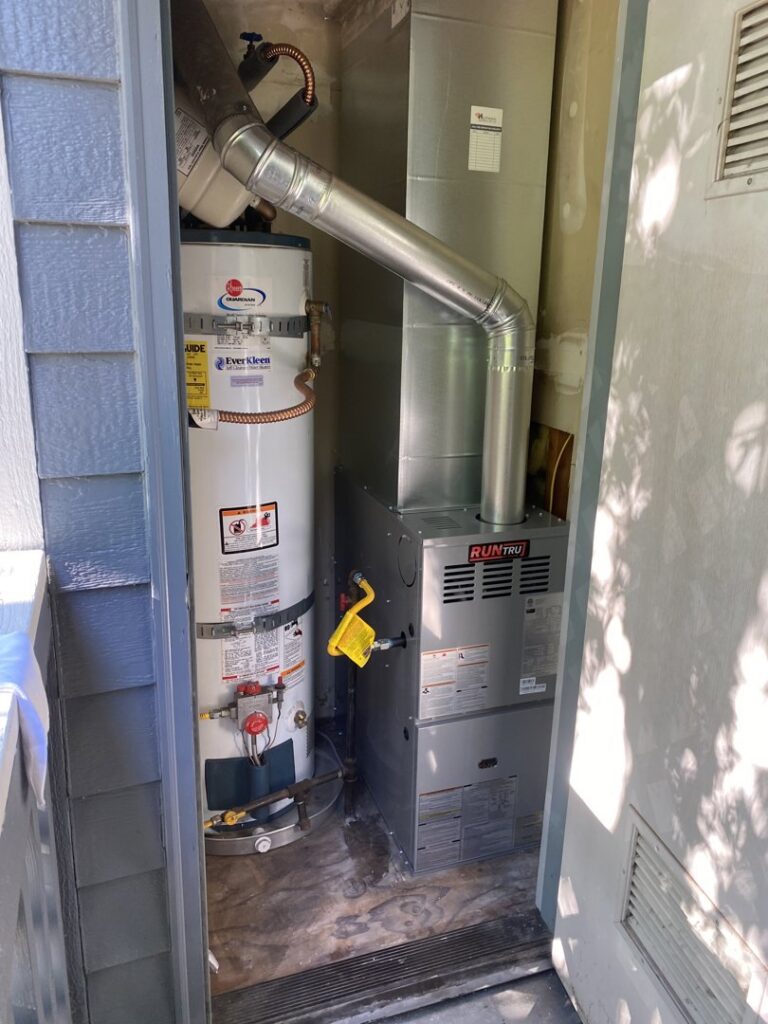 A new furnace and water heater installation in a utility closet by Heatwave Heating & Air LLC in Federal Way, WA.