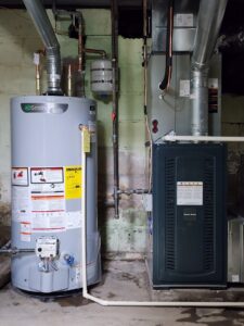 An indoor furnace and water heater installed in a utility room by Xtreme Heating & Cooling in Tulsa, OK