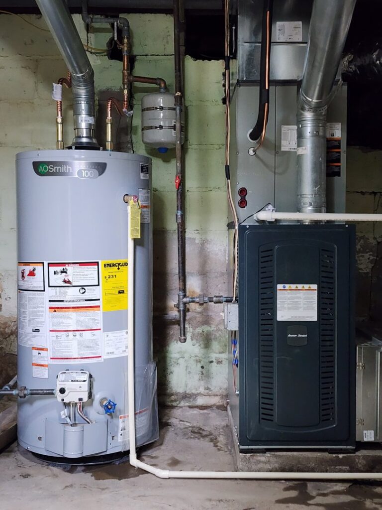 An indoor furnace and water heater installed in a utility room by Xtreme Heating & Cooling in Tulsa, OK