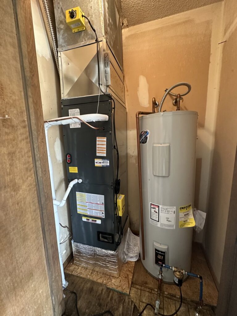 A furnace and water heater installed in a utility closet by One Hour Heating & Air Conditioning of Springfield in Springfield, MO.