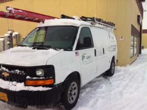 A G&S Management Services HVAC service van with a ladder on the roof, parked in the snow in Anchorage, AK.