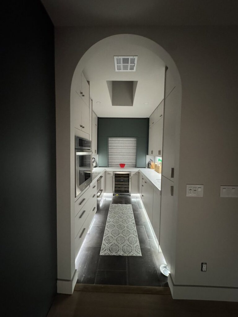 Galley kitchen with stylish under-cabinet and recessed lighting installed by Sparks By Rabbit LLC in Scottsdale, AZ.