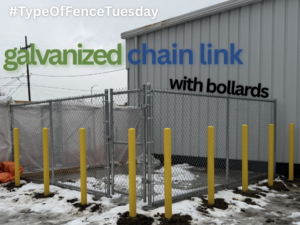 A galvanized chain link fence enclosure with yellow bollards installed by Hi-T Fence Systems in Waterford, PA.