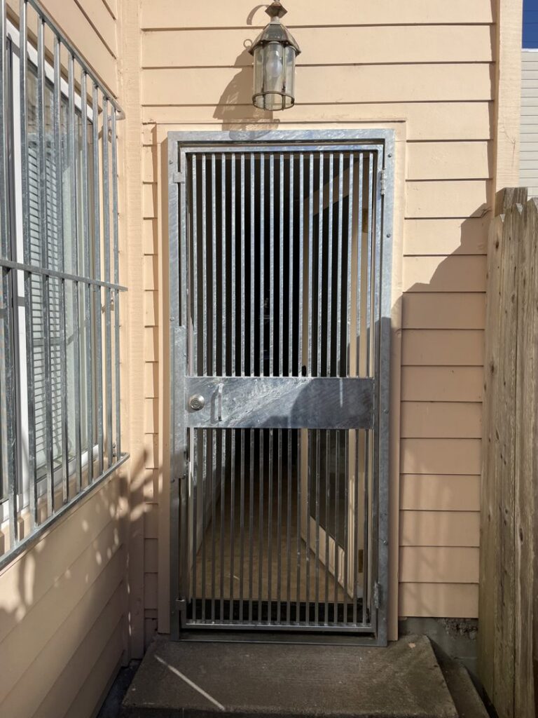 A galvanized metal security door and matching window bars installed by Fierro Iron Works Inc. in San Francisco, CA.