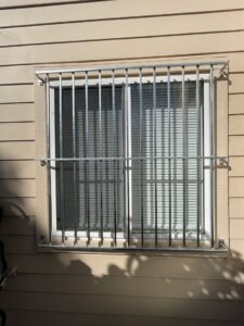 Galvanized metal security bars installed on a window by Fierro Iron Works Inc. in San Francisco, CA.