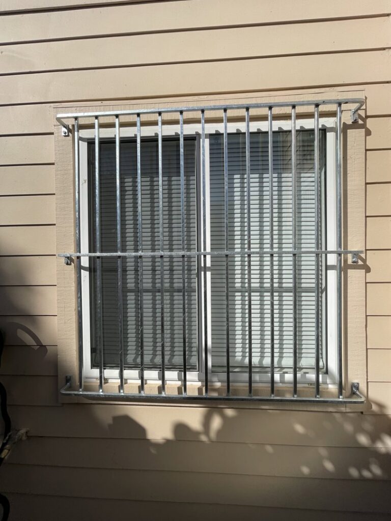Galvanized metal security bars installed on a window by Fierro Iron Works Inc. in San Francisco, CA.