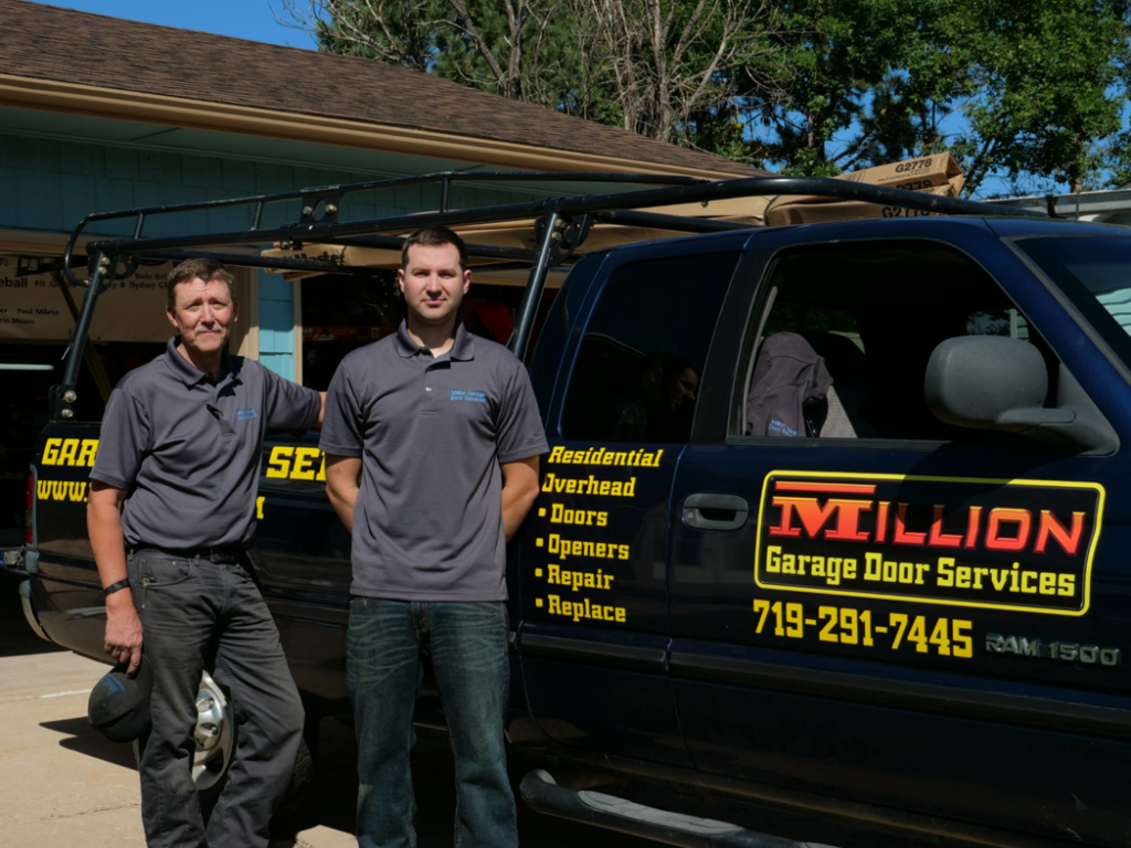 Two Million Garage Door Services contractors standing proudly with their branded service truck in Colorado Springs, CO.