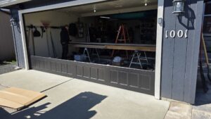 Garage door installation in progress with new panels and a worker from Garage Gecko in Spokane, WA.