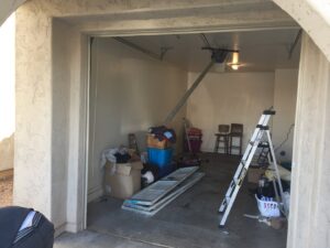 A garage door installation in progress with panels and a ladder by Nate's Garage Door Repair in Scottsdale, AZ.