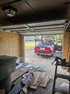 Garage door installation in progress with a contractor's truck outside by The Garage Man in Memphis, TN.