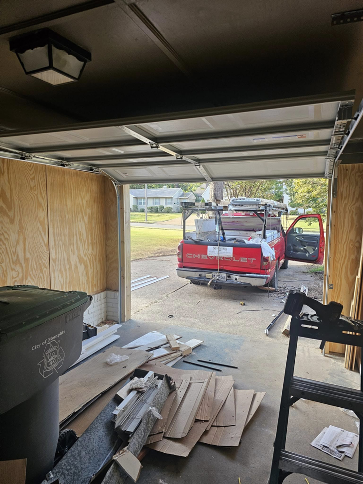 Garage door installation in progress with a contractor's truck outside by The Garage Man in Memphis, TN.