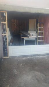 A garage door installation in progress, with new panels and tools visible, by Xpress Doors LLC in Salem, OR
