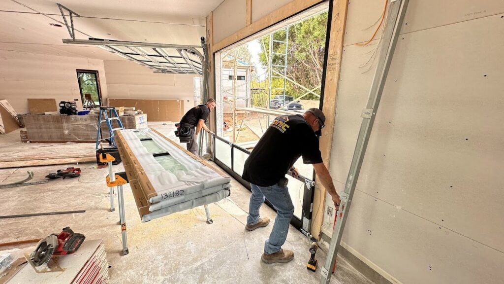 Technicians from Iconic Garage Door Service installing a garage door in a new construction home in Queen Creek, AZ.