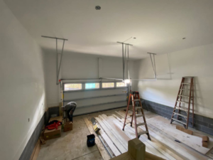 A T&T Garage Door Services technician installing a new garage door in North Vernon, IN.