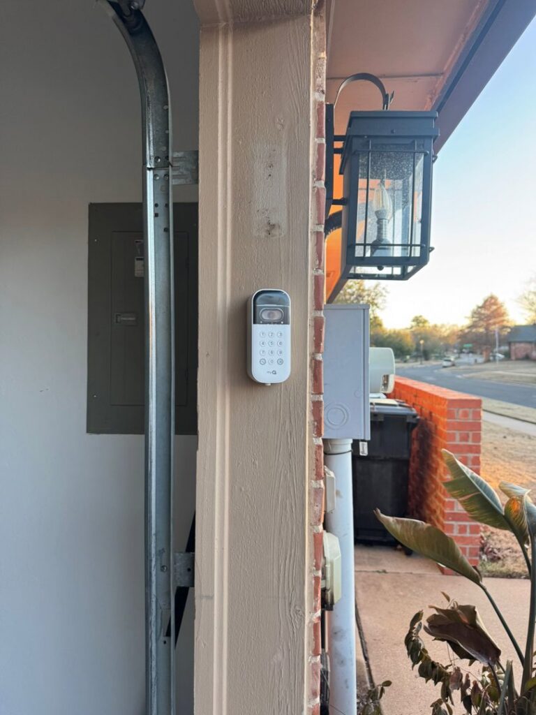 A garage door keypad installed on the exterior wall by 405 Garage Pros in Edmond, OK.