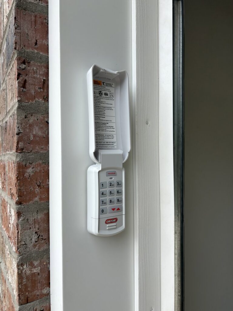 A Genie garage door keypad installed on a residential home by Ozarks Overhead Door & More in Springfield, MO.