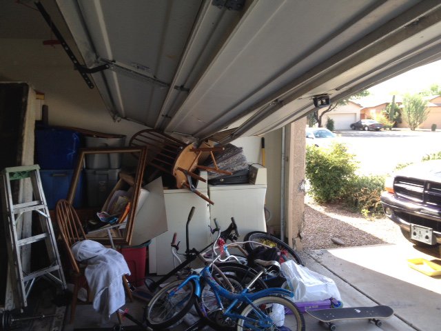A garage door that is off its tracks and jammed, requiring repair from Able Garage Door Service, LLC in Tucson, AZ.