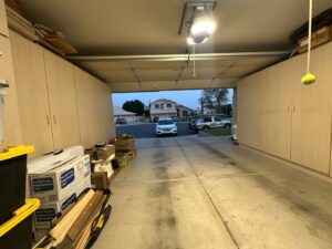 Interior view of an open garage door with a Central Garage Door Repair LLC service truck parked outside in Glendale, AZ.