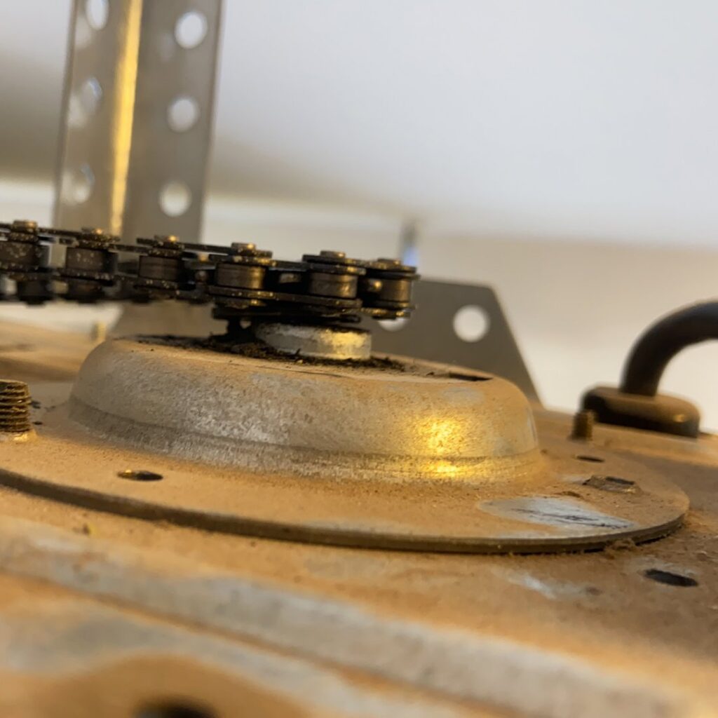 A close-up view of a garage door opener's chain drive mechanism, maintained by MGG Garage Door Service in San Tan Valley, AZ