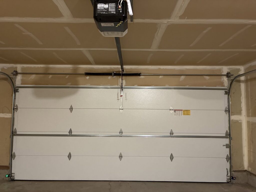 An interior view of a white garage door with a new opener installed by Coast To Coast Garage Door LLC in Vancouver, WA.