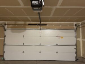 An interior view of a white garage door with a new opener installed by Coast To Coast Garage Door LLC in Vancouver, WA.