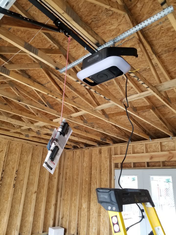 A garage door opener being installed in a newly framed garage, demonstrating work by Community Garage Door Services in Louisville, KY.